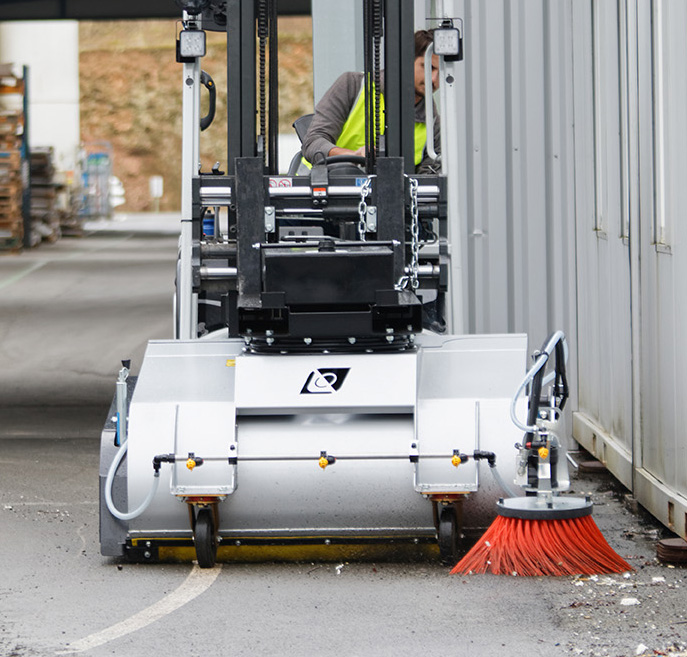 Balayeuse leader'clean en action de nettoyage, montée sur un chariot élévateur